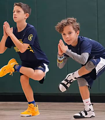 2 Teen Boys doing IYK® Yoga in a Gym