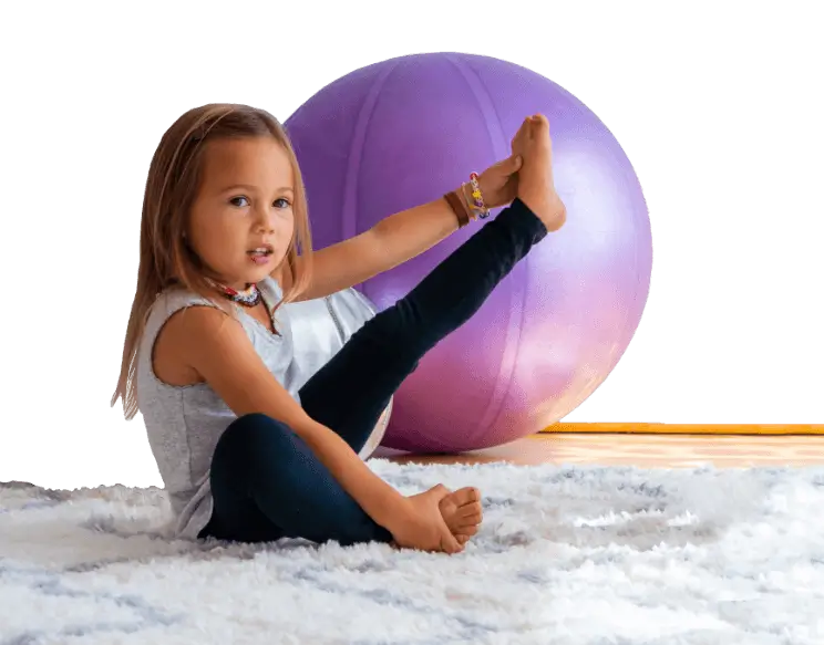 Little girl on a white rug doing yoga.