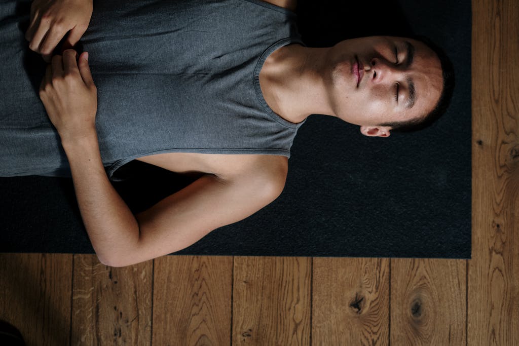 A man resting on his yoga mat