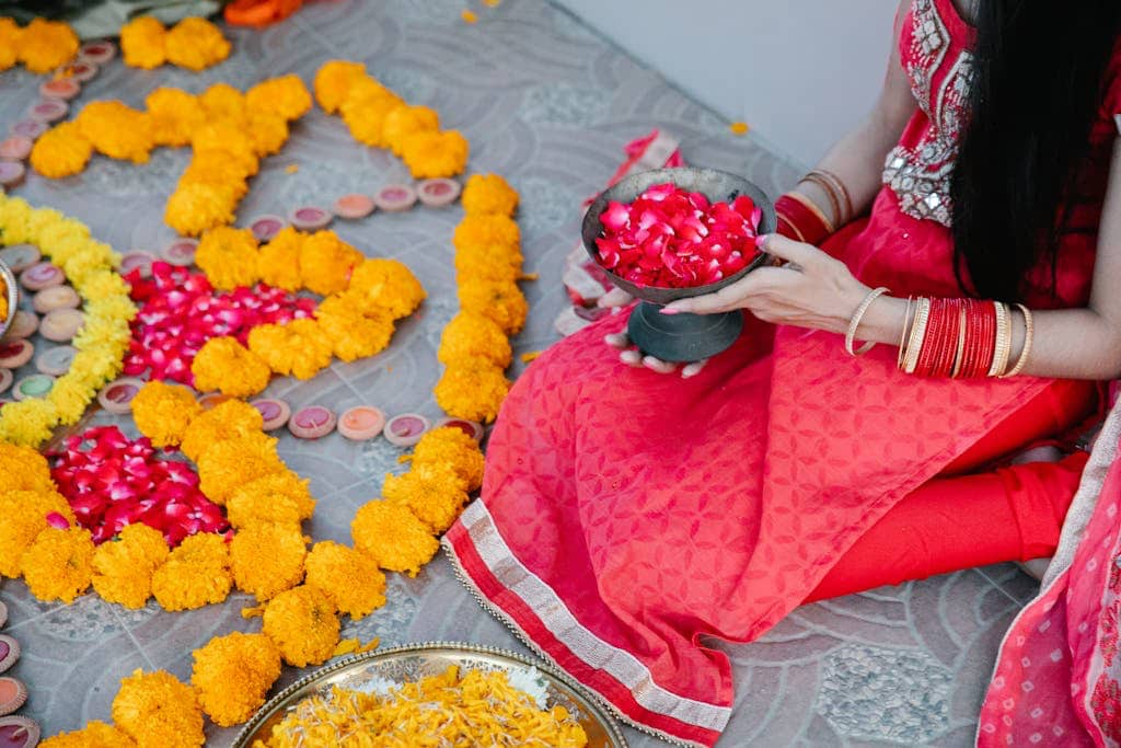 A woman holding flowers for Diwali