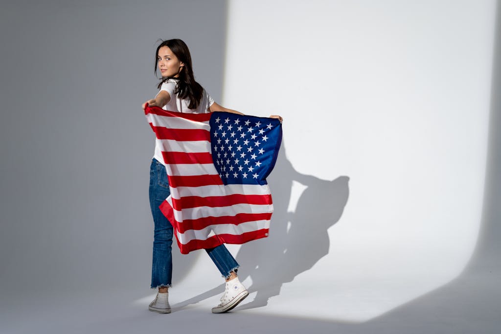 A woman holding a backwards USA flag
