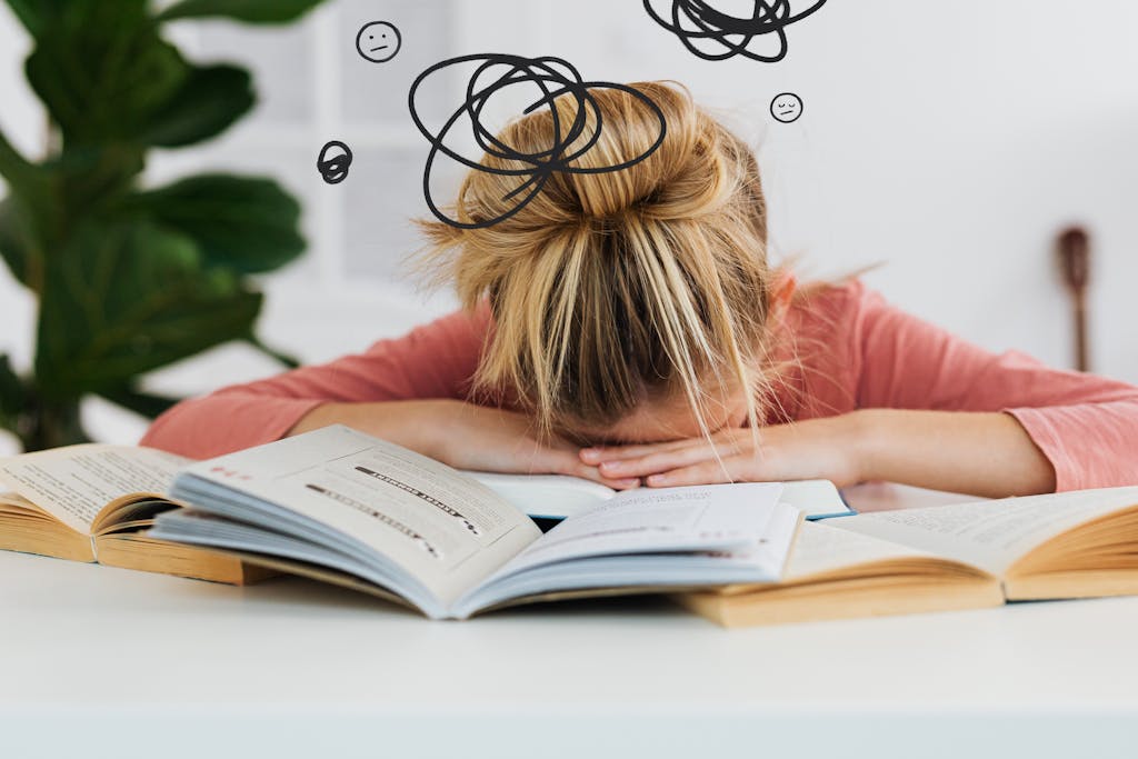 girl studying with her head down on her desk