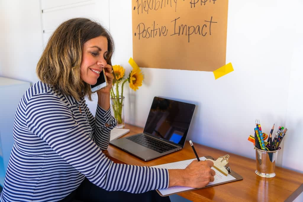 A boss mom working on her yoga business at a desk