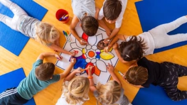 A group of kids coloring a mandala at IYK® Camp