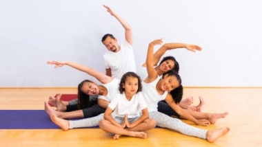 A family doing yoga together at IYK® Family Yoga