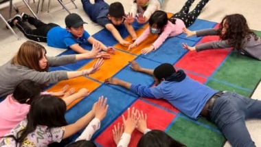 A group of kids practicing yoga with IYK® Yoga at School