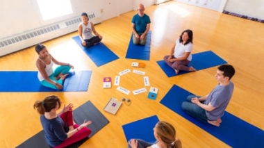 A group of adults learning to teach IYK® Yoga to kids.